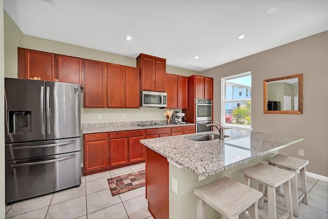 6926 Cucamelon Ct, Windermere, FL 34786 - kitchen featuring stainless steel appliances, light tile patterned floors, light stone countertops, recessed lighting, and a kitchen breakfast bar