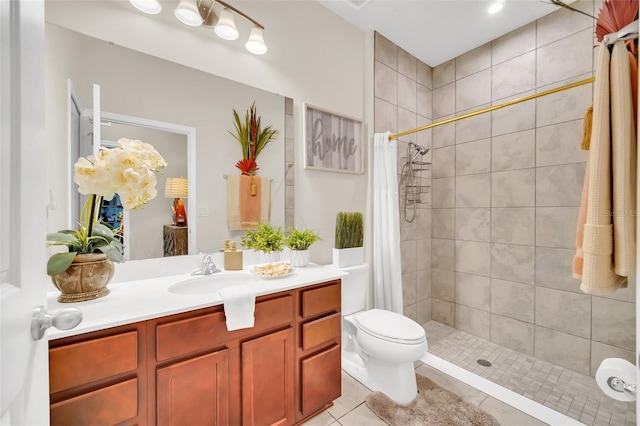 6926 Cucamelon Ct, Windermere, FL 34786 - bathroom featuring vanity, tiled shower, and tile patterned flooring