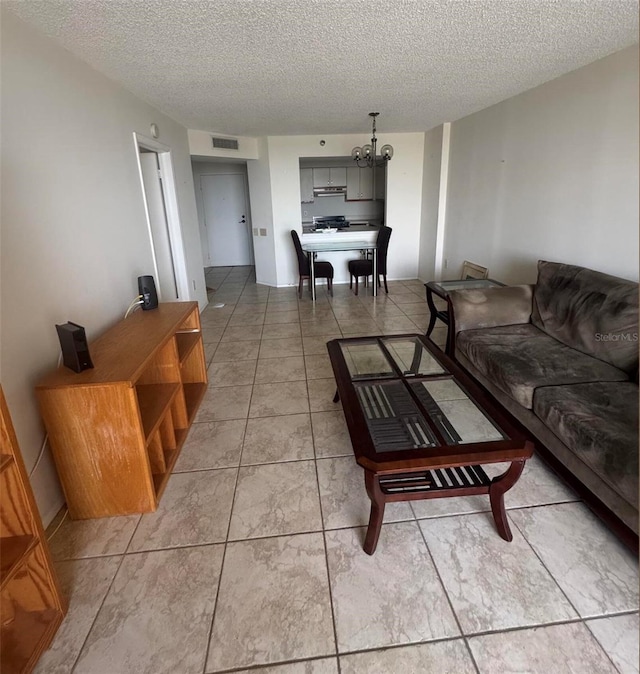 2333 Feather Sound Dr Unit C509, Clearwater, FL 33762 - living area with a chandelier, a textured ceiling, and light tile patterned floors