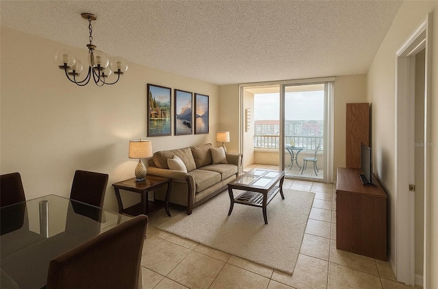 2333 Feather Sound Dr Unit C509, Clearwater, FL 33762 - living room with a chandelier, a textured ceiling, floor to ceiling windows, and light tile patterned floors