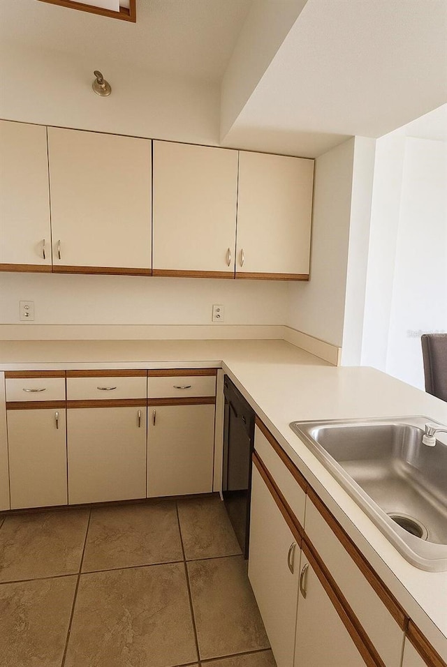 2333 Feather Sound Dr Unit C509, Clearwater, FL 33762 - kitchen featuring light tile patterned floors, light countertops, black dishwasher, and white cabinets