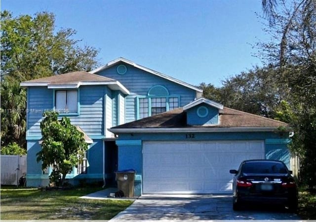 132 Sandalwood Dr, Kissimmee, FL 34743 - traditional home with driveway and an attached garage