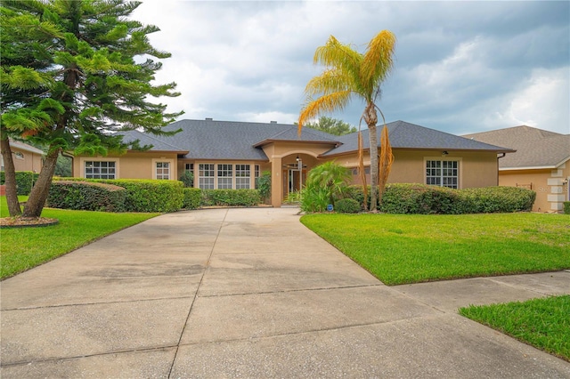 10642 Masters Dr, Clermont, FL 34711 - single story home featuring concrete driveway, stucco siding, and a front lawn