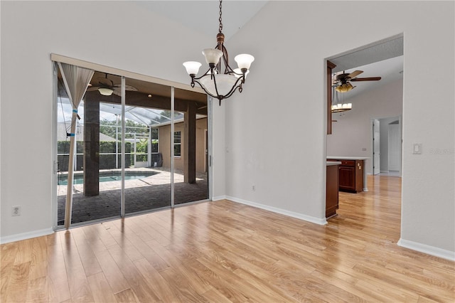 10642 Masters Dr, Clermont, FL 34711 - spare room featuring light wood-style flooring, ceiling fan, a chandelier, and lofted ceiling