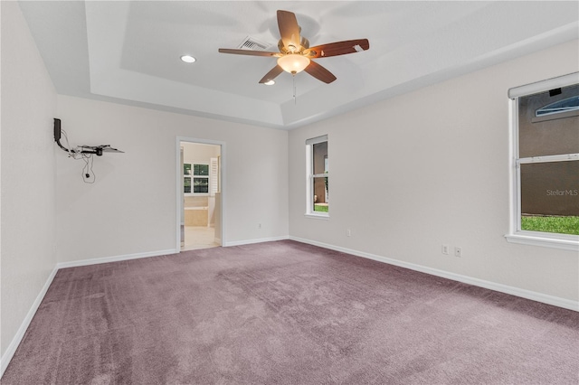 10642 Masters Dr, Clermont, FL 34711 - carpeted empty room featuring a tray ceiling, a ceiling fan, healthy amount of natural light, and recessed lighting