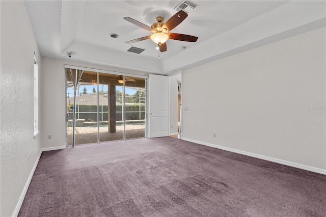 10642 Masters Dr, Clermont, FL 34711 - carpeted empty room with ceiling fan, a tray ceiling, and a textured wall