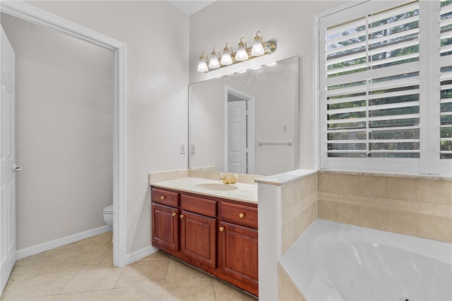 10642 Masters Dr, Clermont, FL 34711 - bathroom with vanity, a tub with jets, and tile patterned flooring