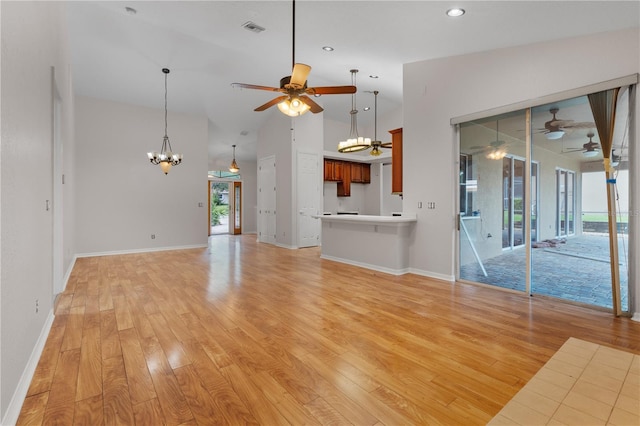 10642 Masters Dr, Clermont, FL 34711 - unfurnished living room with ceiling fan, a chandelier, light wood-style flooring, recessed lighting, and vaulted ceiling