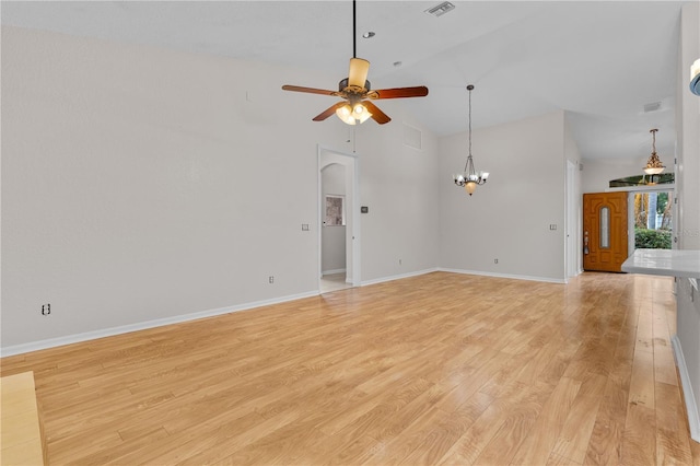 10642 Masters Dr, Clermont, FL 34711 - unfurnished living room featuring a ceiling fan, a chandelier, light wood-style flooring, and high vaulted ceiling