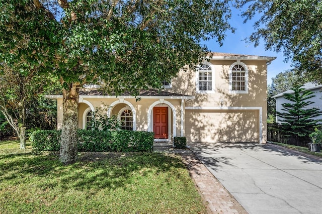 2670 S Palmetto Ridge Cir, Apopka, FL 32712 - view of front of house with stucco siding, driveway, a garage, and a front lawn