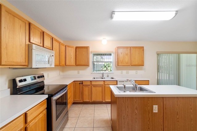 2670 S Palmetto Ridge Cir, Apopka, FL 32712 - kitchen featuring stainless steel electric range, white microwave, light countertops, a kitchen island with sink, and light tile patterned floors