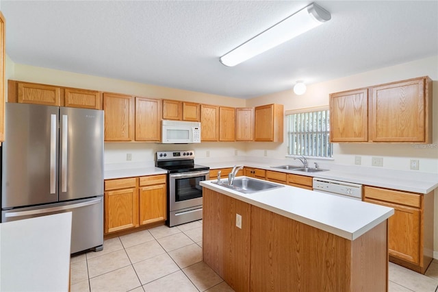 2670 S Palmetto Ridge Cir, Apopka, FL 32712 - kitchen with stainless steel appliances, light tile patterned floors, light countertops, a center island with sink, and a textured ceiling