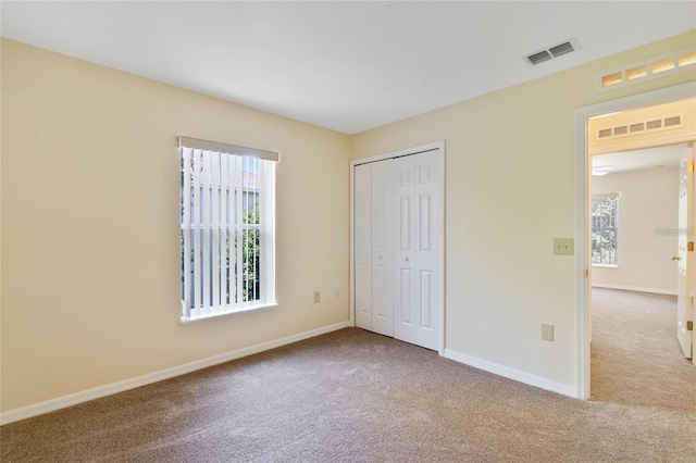 2670 S Palmetto Ridge Cir, Apopka, FL 32712 - unfurnished bedroom featuring carpet, multiple windows, and a closet