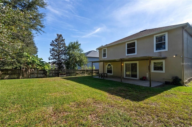2670 S Palmetto Ridge Cir, Apopka, FL 32712 - rear view of property featuring a fenced backyard, a patio area, and stucco siding