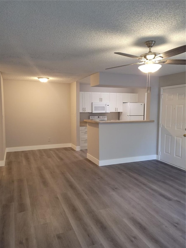 4400 Thornbriar Ln Unit A103, Orlando, FL 32822 - kitchen with white cabinets, white appliances, a textured ceiling, dark wood-style floors, and a ceiling fan