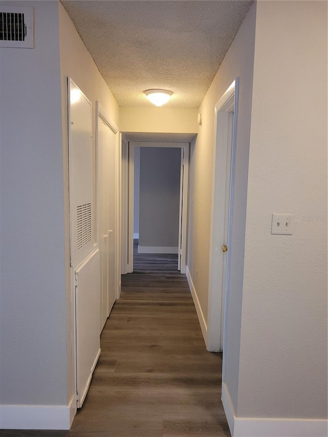 4400 Thornbriar Ln Unit A103, Orlando, FL 32822 - hallway featuring a textured ceiling and wood finished floors