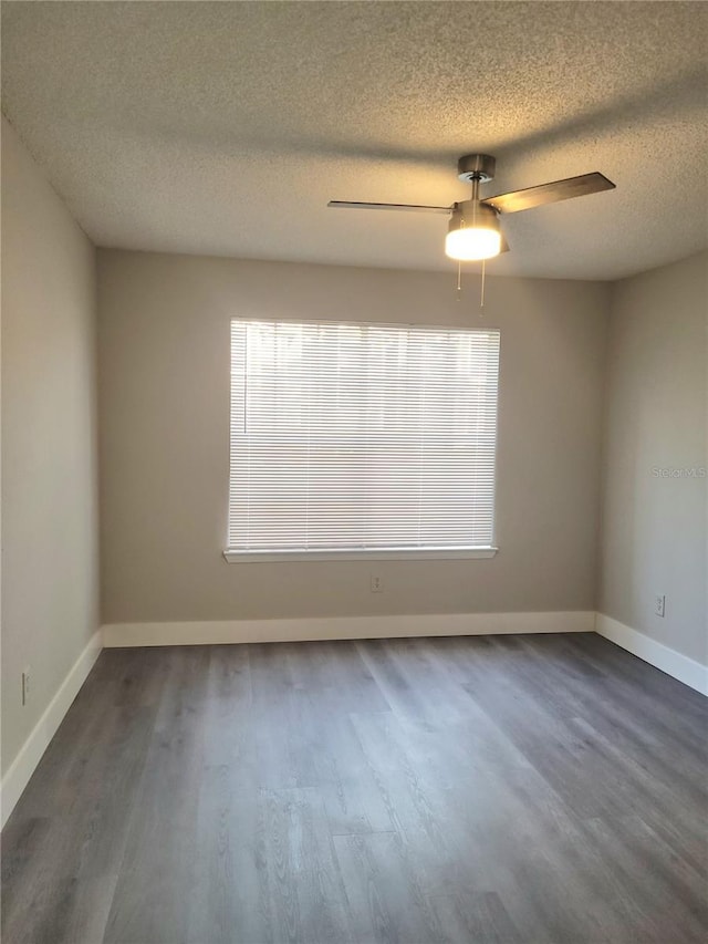 4400 Thornbriar Ln Unit A103, Orlando, FL 32822 - empty room with a ceiling fan, a textured ceiling, and dark wood-type flooring