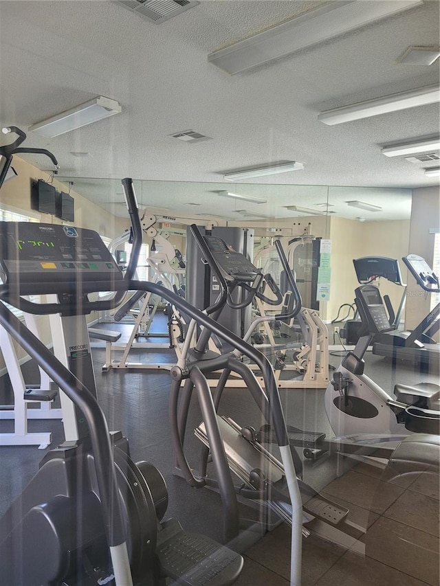 4400 Thornbriar Ln Unit A103, Orlando, FL 32822 - workout area featuring a textured ceiling