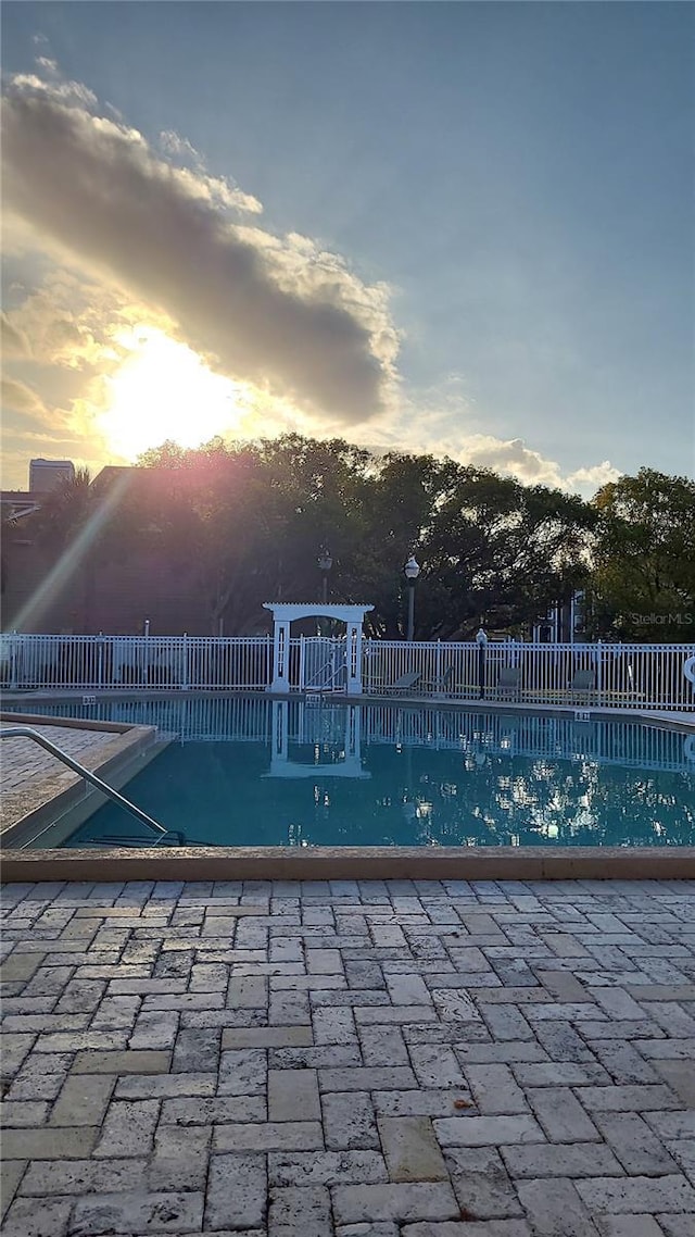 4400 Thornbriar Ln Unit A103, Orlando, FL 32822 - pool at dusk featuring a patio area