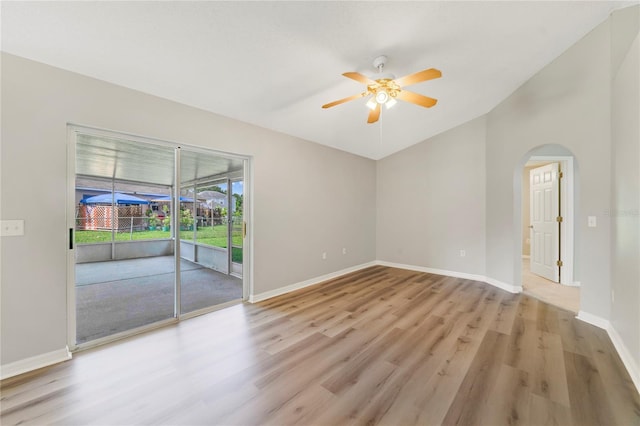 938 Gateshead Ct, Kissimmee, FL 34758 - empty room with a ceiling fan, light wood-style flooring, lofted ceiling, and arched walkways