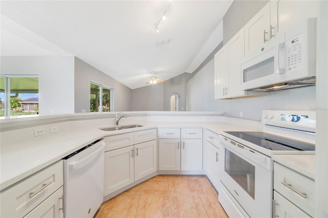 938 Gateshead Ct, Kissimmee, FL 34758 - kitchen with white appliances, ceiling fan, light countertops, vaulted ceiling, and white cabinetry