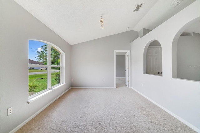 938 Gateshead Ct, Kissimmee, FL 34758 - spare room featuring vaulted ceiling, carpet, and arched walkways