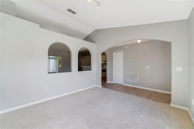 938 Gateshead Ct, Kissimmee, FL 34758 - unfurnished room with carpet floors, vaulted ceiling, and arched walkways