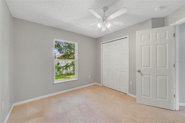 938 Gateshead Ct, Kissimmee, FL 34758 - unfurnished bedroom with carpet floors, a textured ceiling, a closet, and a ceiling fan