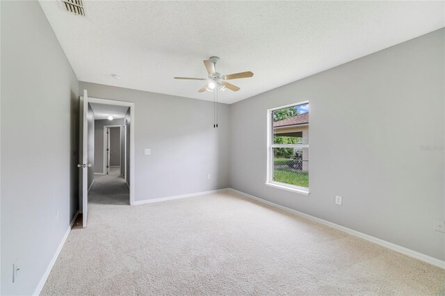 938 Gateshead Ct, Kissimmee, FL 34758 - empty room with ceiling fan, light colored carpet, and a textured ceiling