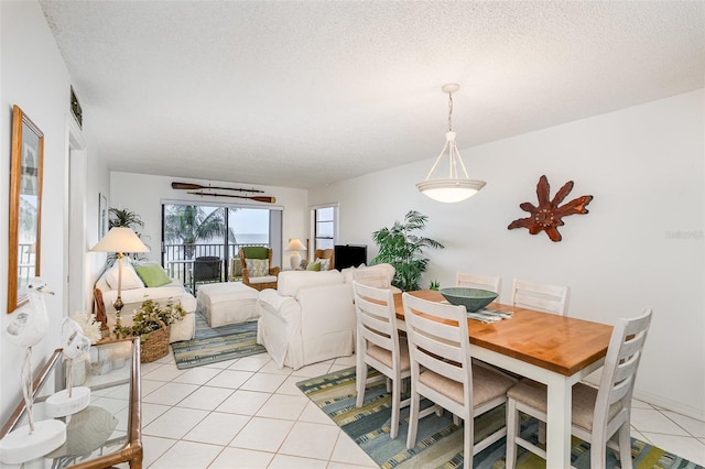 4570 Ocean Beach Blvd Unit 226, Cocoa Beach, FL 32931 - dining space with light tile patterned flooring and a textured ceiling