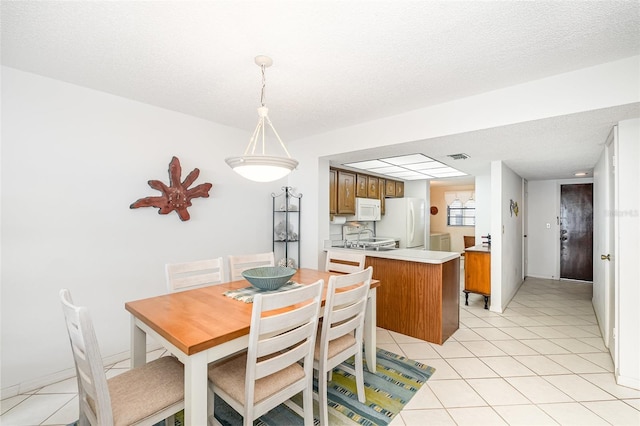 4570 Ocean Beach Blvd Unit 226, Cocoa Beach, FL 32931 - dining area with light tile patterned floors and a textured ceiling