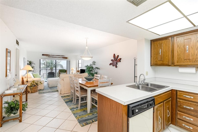 4570 Ocean Beach Blvd Unit 226, Cocoa Beach, FL 32931 - kitchen featuring white dishwasher, open floor plan, brown cabinetry, and light countertops