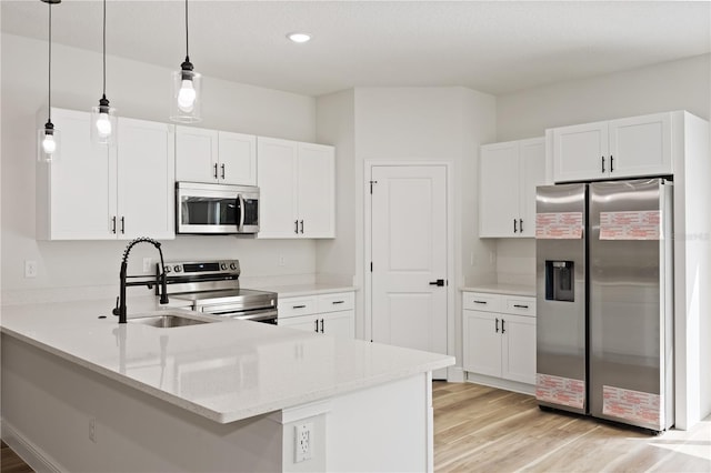 764 Marion Oaks Mnr, Ocala, FL 34473 - kitchen with appliances with stainless steel finishes, a peninsula, light wood-type flooring, hanging light fixtures, and recessed lighting