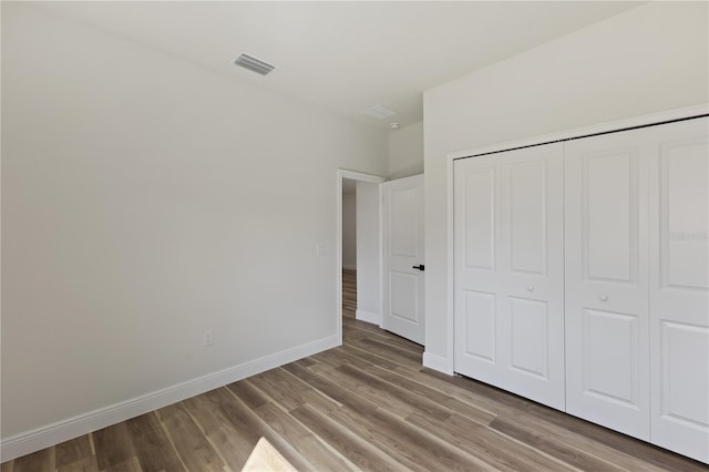 764 Marion Oaks Mnr, Ocala, FL 34473 - unfurnished bedroom with wood finished floors and a closet