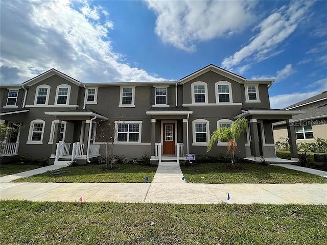 2343 Garden Belle Dr, Clermont, FL 34711 - traditional home with stucco siding and a front lawn