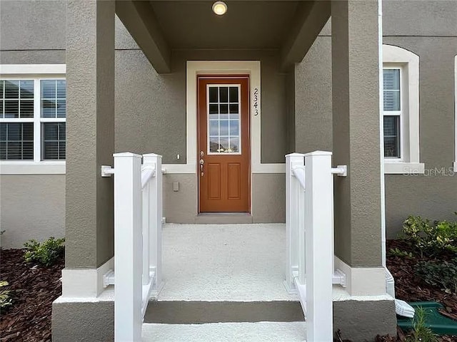 2343 Garden Belle Dr, Clermont, FL 34711 - doorway to property featuring stucco siding