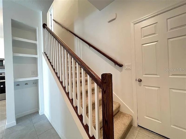 2343 Garden Belle Dr, Clermont, FL 34711 - stairway with tile patterned floors and baseboards
