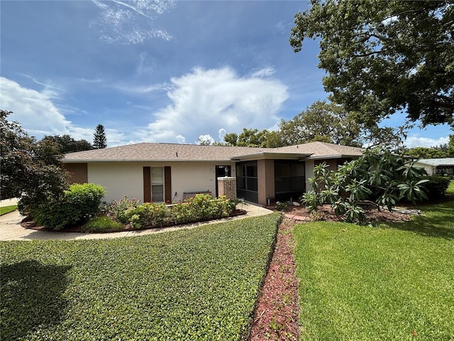 8131 Braddock Cir Unit 1, Port Richey, FL 34668 - view of front facade featuring a front yard, stucco siding, and a shingled roof