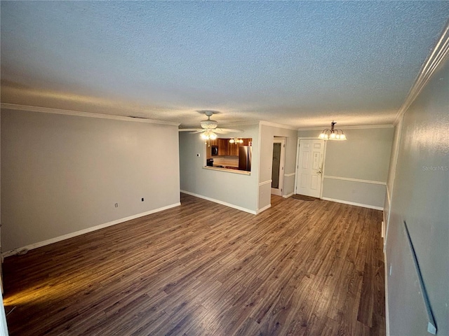 8131 Braddock Cir Unit 1, Port Richey, FL 34668 - unfurnished living room featuring crown molding, a textured ceiling, dark wood-style flooring, ceiling fan, and a chandelier