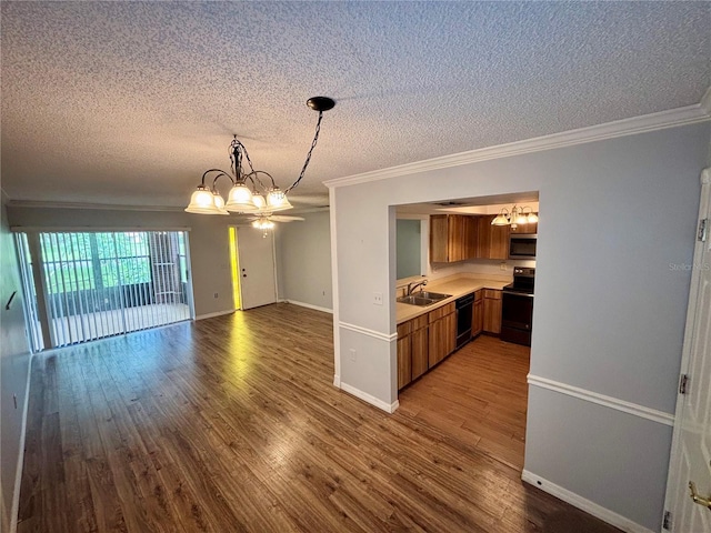 8131 Braddock Cir Unit 1, Port Richey, FL 34668 - kitchen featuring a chandelier, brown cabinetry, ornamental molding, a textured ceiling, and light countertops