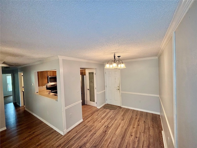 8131 Braddock Cir Unit 1, Port Richey, FL 34668 - spare room featuring wood finished floors, a textured ceiling, ornamental molding, and a chandelier