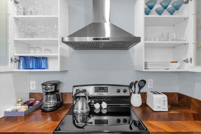 2790 Ocean Shore Blvd Unit 8N, Ormond Beach, FL 32176 - kitchen featuring wall chimney range hood, stainless steel range with electric stovetop, butcher block counters, and open shelves