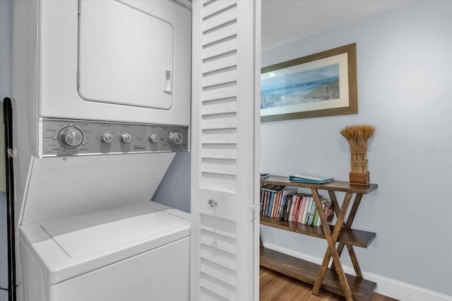 2790 Ocean Shore Blvd Unit 8N, Ormond Beach, FL 32176 - washroom featuring stacked washer / drying machine and wood finished floors