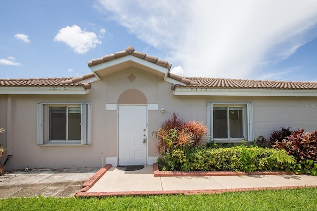 1711 SW 116th Way, Miramar, FL 33025 - view of exterior entry featuring stucco siding and a tiled roof