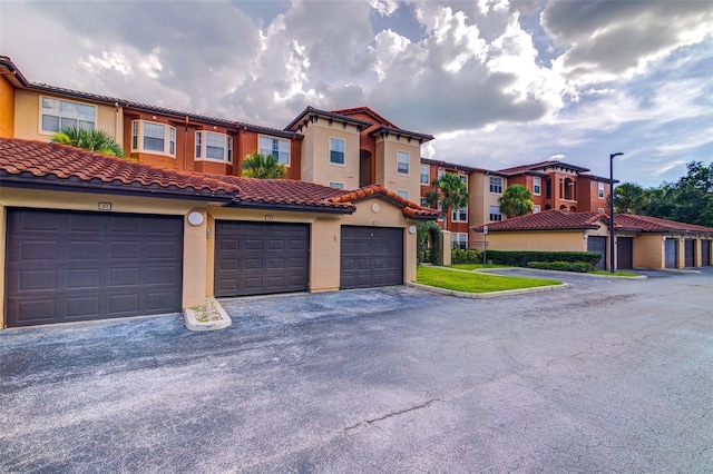 5554 Metrowest Blvd Unit 305, Orlando, FL 32811 - mediterranean / spanish home with community garages, stucco siding, a tiled roof, and a residential view