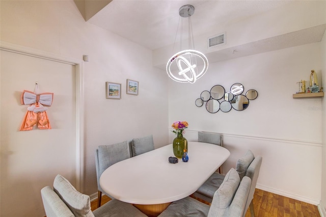 5554 Metrowest Blvd Unit 305, Orlando, FL 32811 - dining space featuring a chandelier and wood finished floors