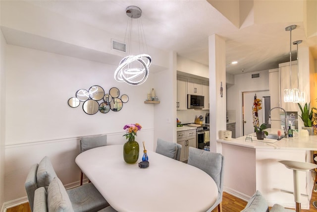 5554 Metrowest Blvd Unit 305, Orlando, FL 32811 - dining space with wood finished floors and baseboards