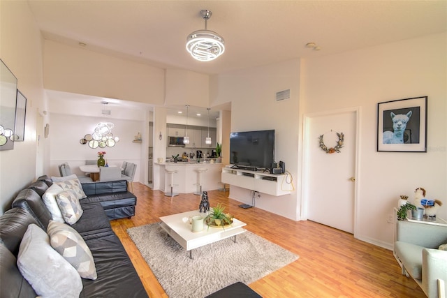 5554 Metrowest Blvd Unit 305, Orlando, FL 32811 - living area featuring light wood-type flooring and high vaulted ceiling