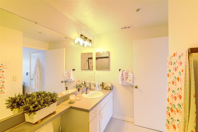 5554 Metrowest Blvd Unit 305, Orlando, FL 32811 - full bathroom featuring vanity and a textured ceiling