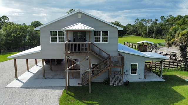 view of front of house featuring a front lawn and a patio